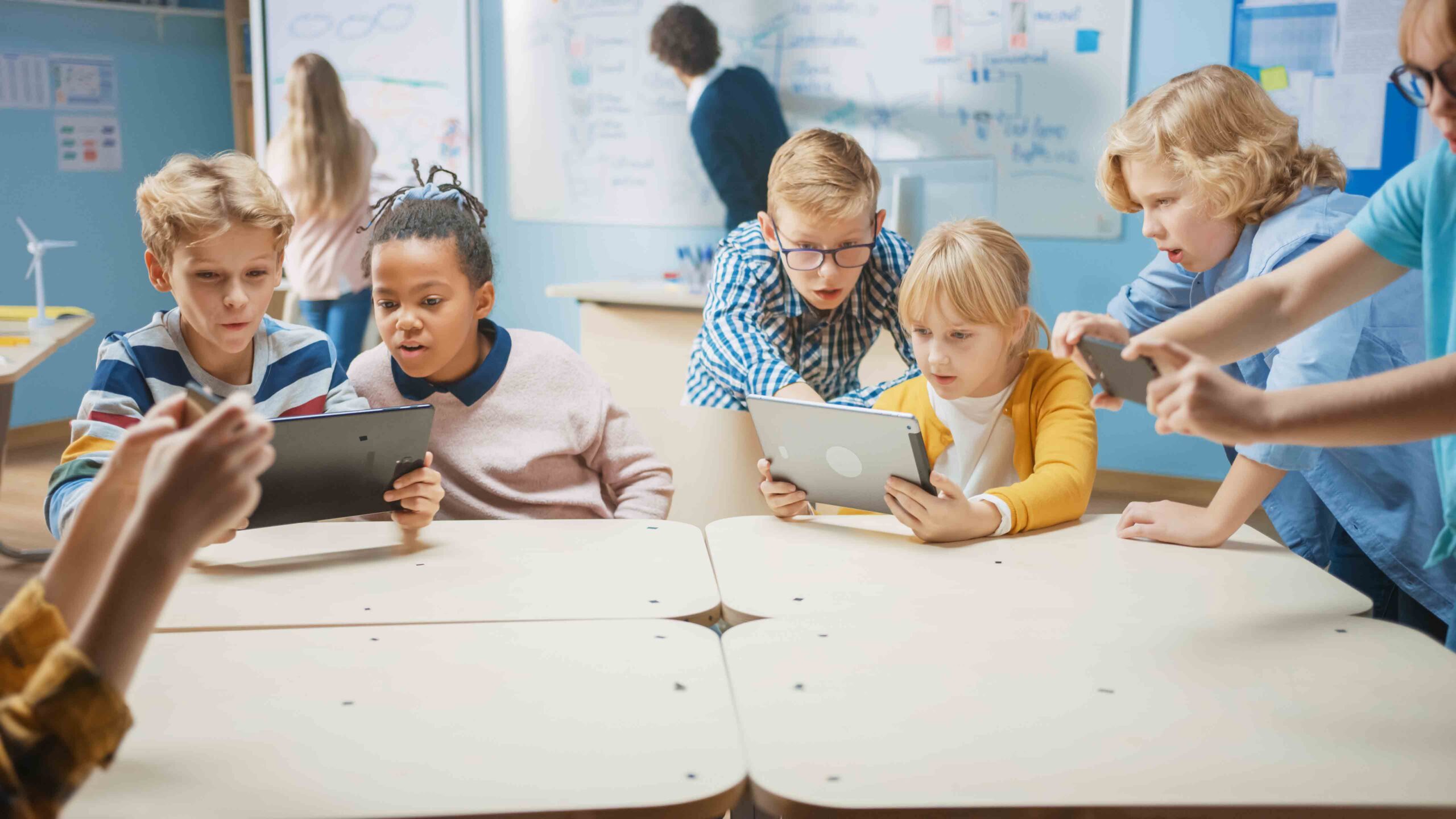 Elementary School Computer Science Class: Children Use Digital Tablet Computers and Smartphones with Augmented Reality Software, They're Excited, Full of Wonder. Children in STEM, Playing and Learning